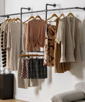 Heavy Duty Industrial Pipe Clothing Rack With Four Hanging Rods Wall Mounted Garment Rack Black Steel Frame showcasing various outfits.