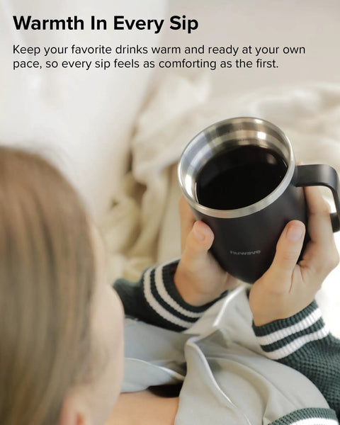 Rechargeable Self Heating Coffee Mug With Adjustable Temperature Control And Charging Base 16 Oz cup held by a person, enjoying warm coffee.