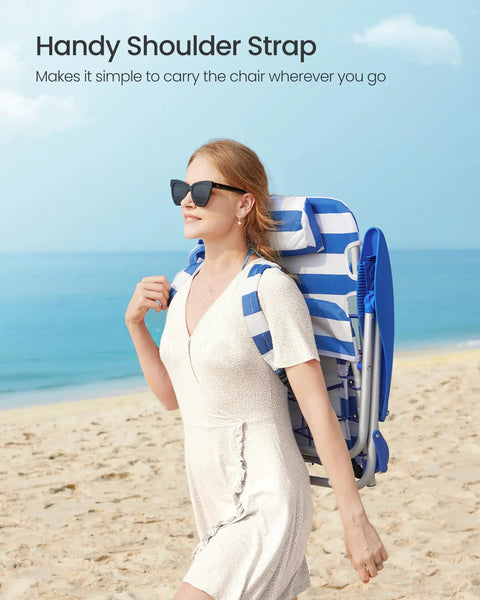 Woman carrying Backpack Beach Chair With Four Adjustable Backrest Angles, 331 Lb Capacity, foldable, blue and white at the beach