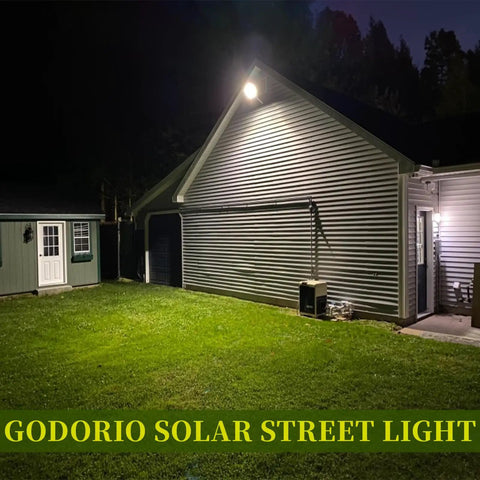 4 Pack Solar Street Lights Outdoor 279 LED Waterproof Wall Lights illuminating a driveway at night, showcasing energy saving security lighting.