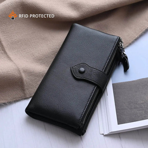 Women's Soft Leather RFID Blocking Bifold Slim Wallet with Double Zipper Pockets, black, closed, on a table.