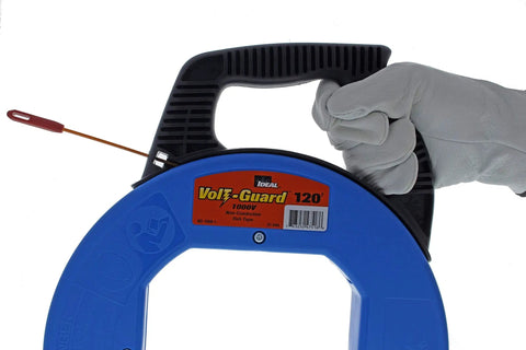 Gloved hand holding VoltGuard Fish Tape For Electricians 120 Ft Pulling Tape With Non Conductive Eyelet And Fiberglass Core