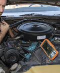 Mechanic using WiFi Pro Borescope With Dual Lens 5.5 mm 9.8 Foot Armored Waterproof Gooseneck Endoscope to inspect car engine