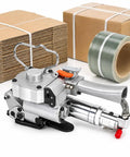 Handheld Pneumatic Baler Strapping Tool With 3500 N Automatic Tensioning Welding And Cutting Function For Buckle Free Packaging Of Heavy Duty PP PET Straps In Factory Warehouse Settings Effortlessly beside stacked boxes and strap roll.