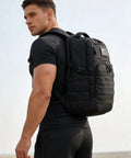 Side view of person wearing Durable Military Style Tactical Backpack For Men 30L 20 Inch Assault Pack In Black With MOLLE System