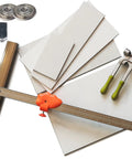 Pro Grade Manual Tile Cutter For Porcelain And Ceramic Tiles With 48 Inch Large Format Cutting Capacity Includes Running Pliers Tungsten Scoring Wheels And Cutter Heads For Precise Clean Cuts Every Time For DIY Projects showing cutter, pliers, and scoring wheels on tiles