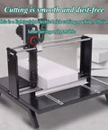 Real Deal Three Thousand Watt Electric Brick Cutter For Aerated Blocks Foam Boards And Wood Chews Through Concrete Hard Masonry Like Butter Comes With Spare Chain Built Tough on a black cutting table with foam blocks.
