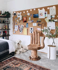 Premium Natural Cork Roll Four Feet By Twenty Four Feet Long Half Inch Thick used as a pinned board behind a wooden hand chair.