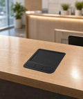 Industrial Touchpad Mouse Panel Mount Controller, Wired USB Interface With Mounting Profile, Rectangular Housing, Coiled Cable, Built For Secure Cabinet Installations And Embedded Control Panels Plug And Play Ready. Black panel mount touchpad on wood desk