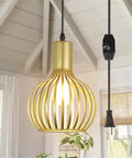 Black Pendant Light With Vintage Industrial Vibe in a rustic kitchen setting, hanging from a beamed ceiling.