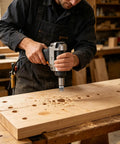 Man using Eight Piece Premium Black Wood Plug Cutter Drill Bit Set Featuring Straight And Tapered Shapes with drill on wooden board.