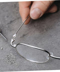 Close-up of Metal Eyeglasses Repair Screws Kit, Small Replacement Set For Glasses, Sunglasses, And Watches, includes screw and tool.