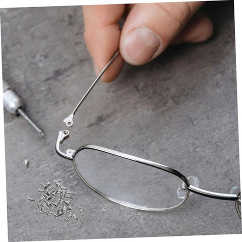Close-up of Metal Eyeglasses Repair Screws Kit, Small Replacement Set For Glasses, Sunglasses, And Watches, includes screw and tool.