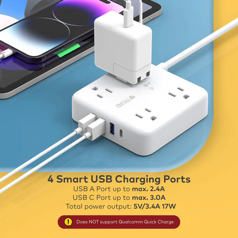 15ft Flat Plug Power Strip With 4 Widely Spaced Outlets And 4 USB Ports Including USB C, white next to phone charging.