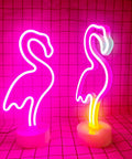 Two pink flamingo LED neon light signs for bedroom and girls room decor, USB or battery powered, on round stands, glowing warm light