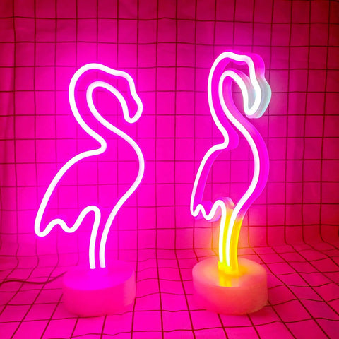 Two pink flamingo LED neon light signs for bedroom and girls room decor, USB or battery powered, on round stands, glowing warm light