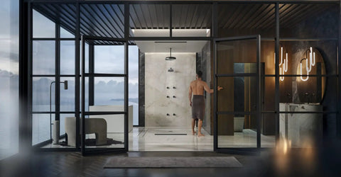 Modern bathroom with glass walls and a person near shower area demonstrates Anthem Digital On Off Remote Control For Shower System Sleek Wireless Button That Makes On And Off Actuation A Breeze For Handheld With Hose Tub Spout Or Fixed Shower Head functionality.