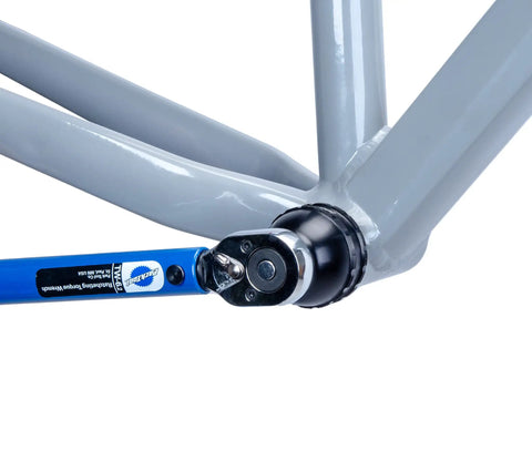 Blue Bottom Bracket And Pedal Tool For Pro Grade Bike Maintenance, 16 Notch Socket Fits Shimano XTR BB93 And Dura Ace BB9000, Token Bottom Brackets, And STEPS Chainring Lockrings, The Do It All Tool For Quick Installations And Removals being used on bike frame
