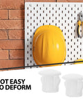 White Plastic Screw End Caps And Hole Plugs 100 Pack For Homes, Offices And Commercial Spaces shown with tools on pegboard