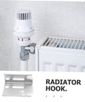 Steel radiator hook next to radiator valve seen in a domestic setting, showing installation configuration for holding pipes.