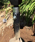 Round Shank Two Slot Drill Bit Adapter For Electric Drills And Earth Augers Universal Head Connector in a garden setting