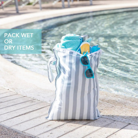 Big Waterproof Wet Bag Two Pack For Travel And Swim Gear by poolside, holding towels and sunglasses, gray and green stripe design