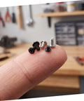 50pcs OLED Console Screw Kit With Multi Size Hardware For Gamepads And Controllers Anti Corrosion Screws Set For DIY Repair Maintenance And Modding Of Gaming Consoles, close-up screws on fingertip