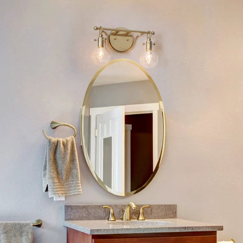 Two Light Gold Vanity Light With Clear Glass Shades For Bathroom above a mirror in soft gold finish, 14x4.5x8 inches