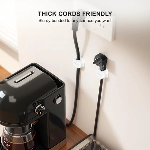 Magnetic Cable Clip Organizer Pack For Car Desk Nightstand And Wall Mount Adhesive Cord Holder Keeps USB Cables And Chargers Neat No Mess 0.3 Inch Slot Fits Most Cables Wire Keeper For Home Office shown securing power cables on wall.