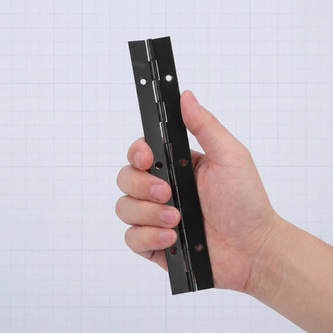 Person holding one of the 4 Pack Black Stainless Steel Piano Hinges 6 Inch Continuous Woodworking Hinges for solid wood cabinets.