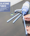 Hands assembling No More Heavy Lifting Manual Water Pump for 5 Gallon Bottles, BPA-Free with silicone tubing on dark surface.