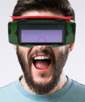Top Shelf Auto Darkening Welding Goggles With Rugged Impact Resistant Lens For Hardcore Industrial And Garage Work Fast Trigger Shock Resistant Safety Specs on a man.