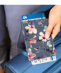 Person holding Slim RFID Passport Holder Travel Wallet With Card Slots, Blooming Hibiscus Design, by blue luggage