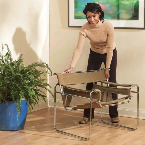Person moving chair using Self Stick One Half Inch By Four Inch Furniture Sliders For Carpet And Hard Surfaces Beige Four Pack