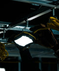 Heavy Duty 100 FT LED String Work Lights X Shaped Uplight installed in a construction site, showing rugged build and yellow cord.