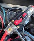 Top Shelf 40 Amp Auto Circuit Breaker in engine bay, waterproof inline fuse with manual reset, red and black wiring.