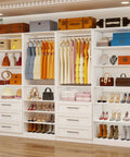 Four Piece Modular Closet Organizer System Featuring Six Roomy Slide Out Drawers Six Flexible Hanging Rods And Fifteen Spacious White Shelves Crafted From Heavy Duty Panels For Zero Hassle Walk In Storage, showcasing dresses, bags, and shoes.