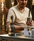 Kick Up Your Daily Brew Game With This Portable Electric Coffee Grinder Featuring 45 Precision Settings And Stainless Steel Conical Burrs A Straight Up Game Changer For Espresso Pour Over Drip Or Cold Brew Creations All Day on a camping table with a man.