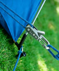 Close-up of Six Pack Metal Rope Adjusters With Rustproof Brass Cam Tensioners and 9 Foot Reflective Braided Cords securing a tent