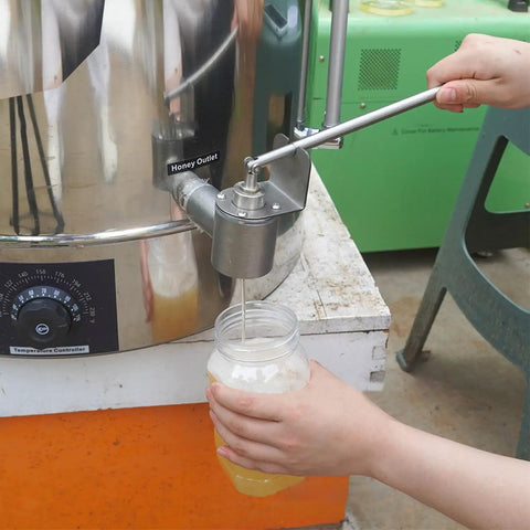 Using stainless steel dripless honey bottling valve with 1 inch NPT thread on extractor for mess-free honey flow into a jar