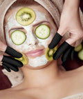 Ace Every Shift With This 400 Pack Black Latex Finger Cots Kit, model using fingertip guards during a facial treatment.