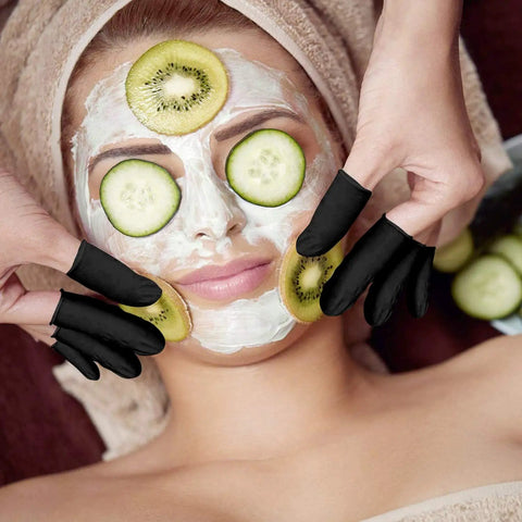 Ace Every Shift With This 400 Pack Black Latex Finger Cots Kit, model using fingertip guards during a facial treatment.