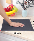 Person's hand resting on 12x12 inch dark grey 100 Percent Pure Cotton Waffle Weave Dish Cloths 6 Pack Ultra Absorbent Honeycomb.