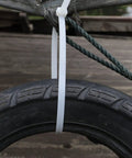 Beefy 24 Inch Zip Ties Pack Of 50 Heavy Duty Cable Ties For Outdoor Use attached to a tire and rope, showcasing strength and durability