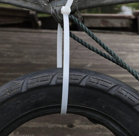 Beefy 24 Inch Zip Ties Pack Of 50 Heavy Duty Cable Ties For Outdoor Use attached to a tire and rope, showcasing strength and durability