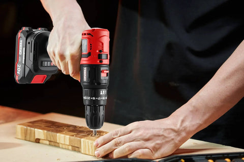 Person using 20V Brushless Cordless Drill And Impact Driver Combo Kit With 2 In 1 Interchangeable Heads on wooden board