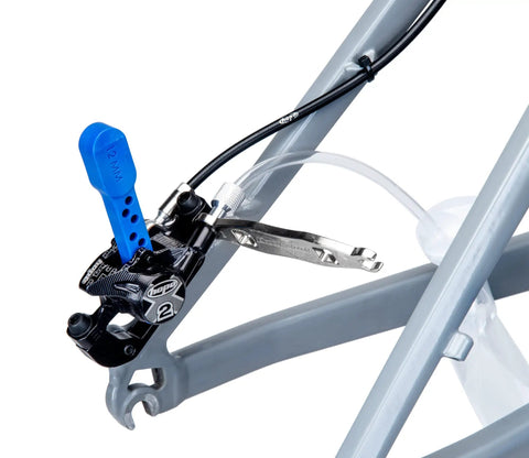 Close-up of Heavy Duty Hydraulic Bicycle Brake Bleed Kit with caliper, mounted bleed block, and hose connection for SRAM.