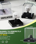 Clear Acrylic Golf Ball Display Case With Secure Locking System shown displaying a golf ball on a desk, highlighting velvet interior.