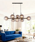 Black Glass Ball LED Pendant Light Transparent Globe Housing Decorative Hanging Fixture Chandelier Ceiling Light in modern living room setting.