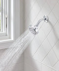 Ignite Chrome Five Function Shower Head With 2.5 GPM High Pressure Spray in a modern bathroom setting